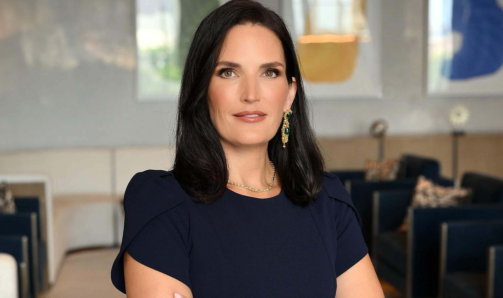 Professional woman posing in stylish indoor setting.